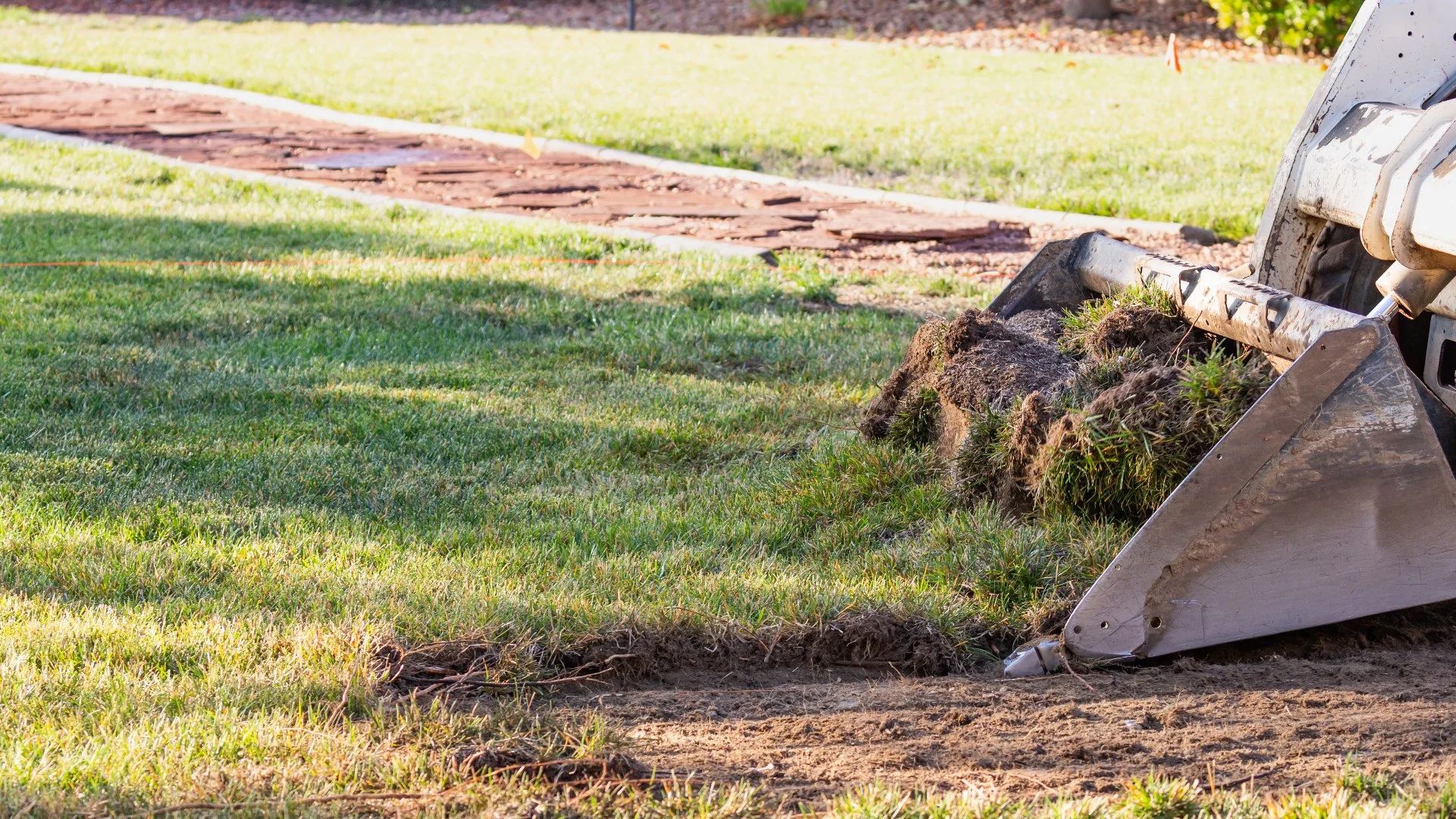 Landscape construction underway on a section of an occupied commercial property