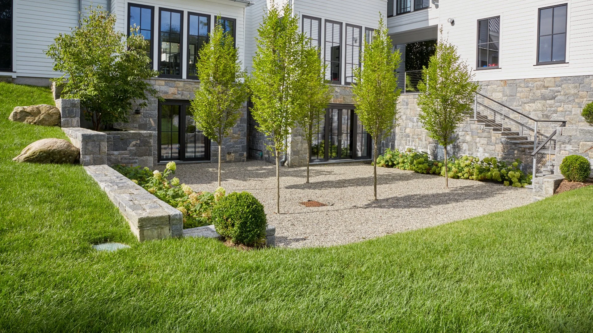 Elegant landscaped garden with stone features in %%targetarea1%%, NY