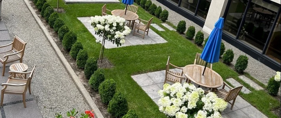 Commercial courtyard in White Plains, NY, with plants, grass, and patios.