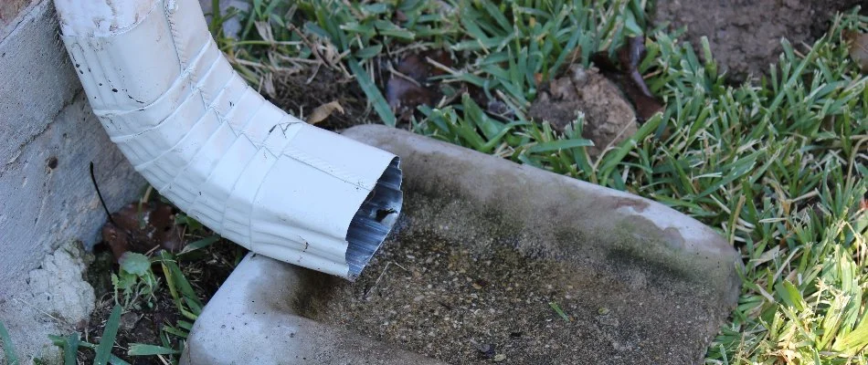 Downspout drain alongside a house in White Plains, NY.