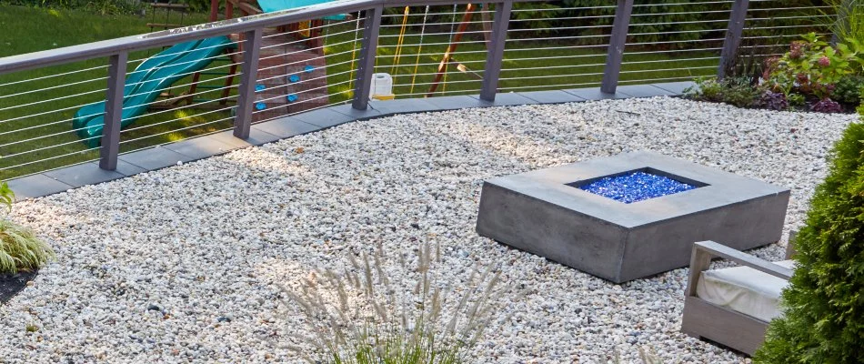 Gas fire pit on a gravel patio in White Plains, NY.