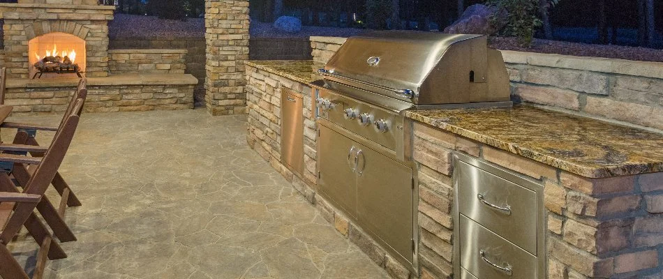 Outdoor kitchen in White Plains, NY, with appliances and a fireplace.