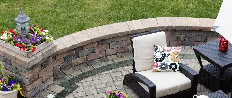 Seating wall on a patio with outdoor furniture.