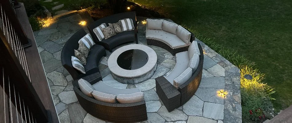 Stone patio in White Plains, NY, with furniture.