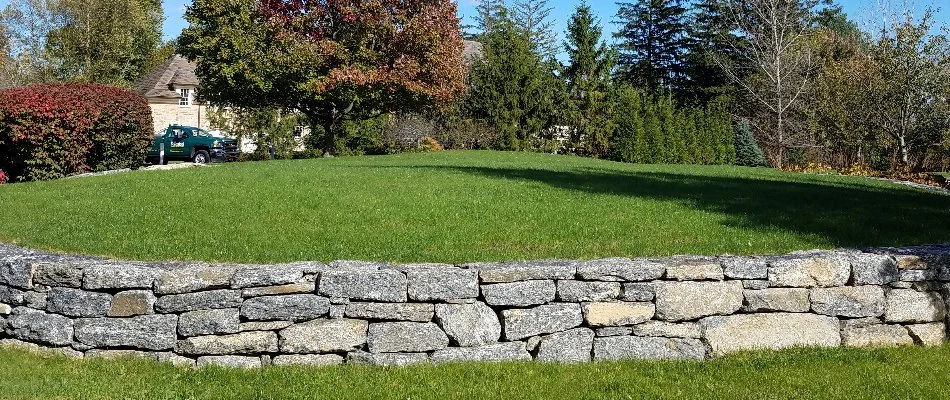 Stone retaining wall and green grass in White Plains, NY.