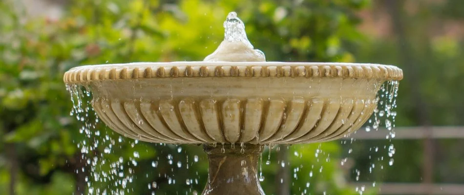 Water fountain with water flowing over the side.