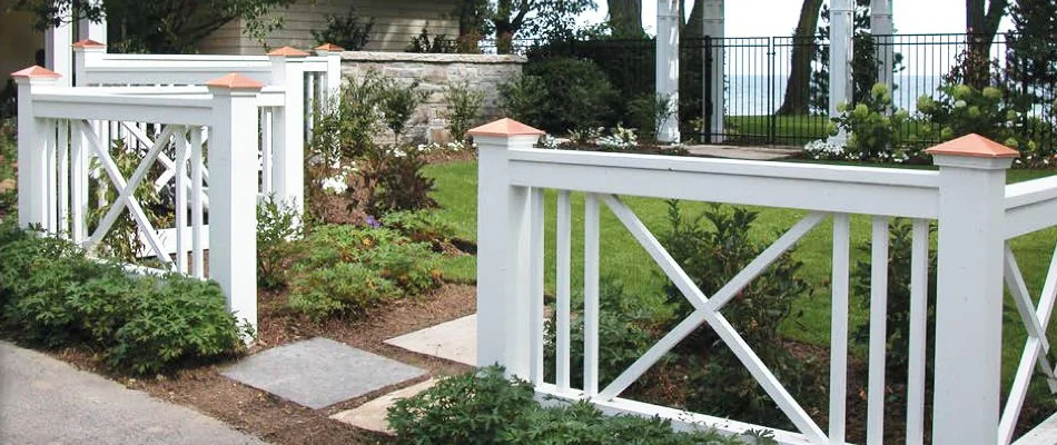 White fence around a landscape and grass in White Plains, NY.